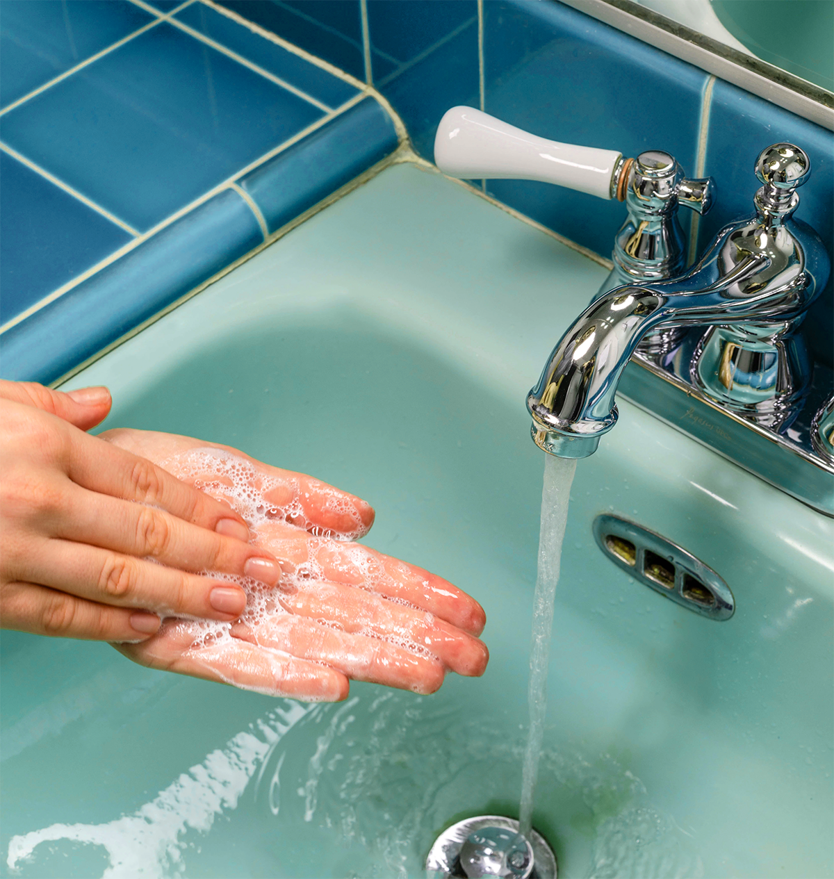 Washing hands in the sink.