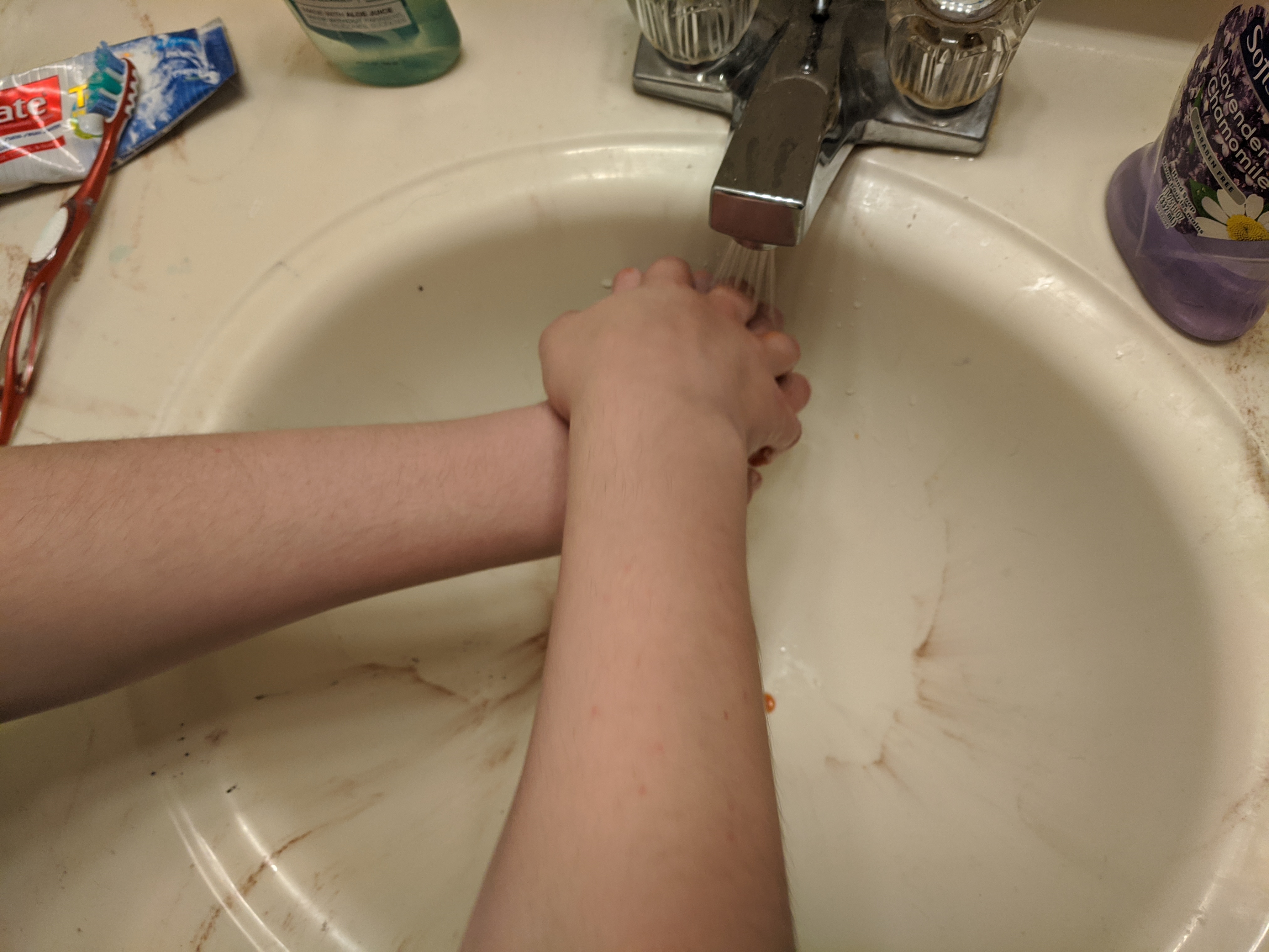 right palm washing back of left hand